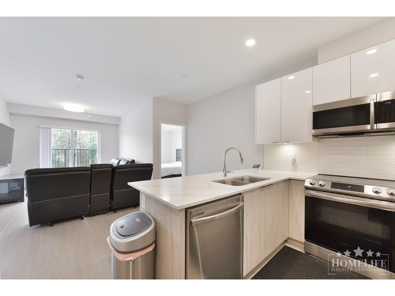 A modern kitchen with a dishwasher and a stove top oven.