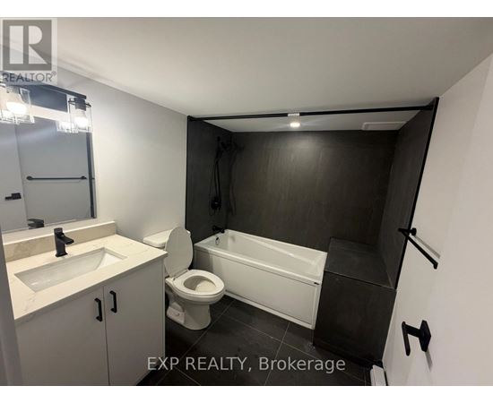 A bathroom with a toilet, sink, and bathtub.