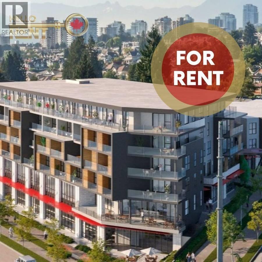 A modern apartment building with a red banner that reads "FOR RENT" in front of it.