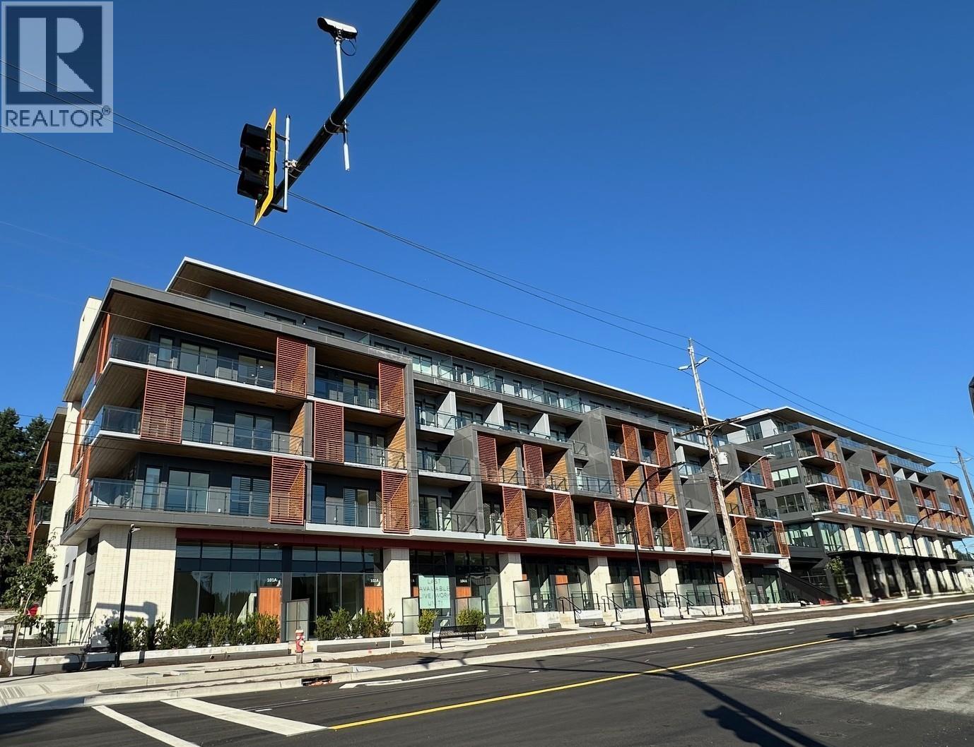 A modern apartment building with a clear blue sky above.