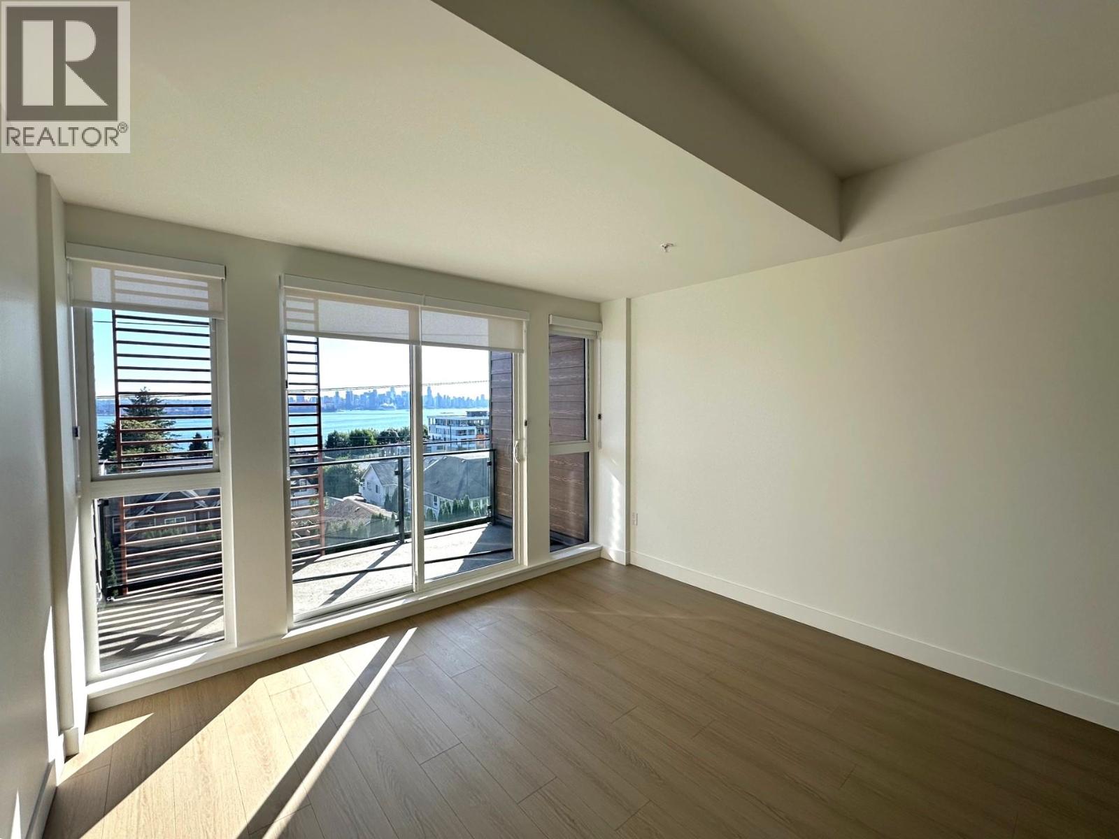 A room with a sliding glass door leading to a balcony.
