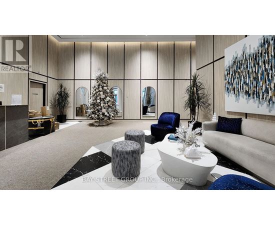 A modern living room with a Christmas tree and a large painting on the wall.