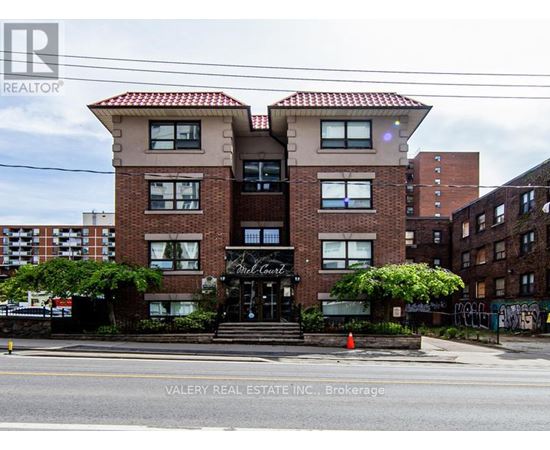 A building with a sign that says "Valery Real Estate Inc., Brokerage" in front of it.