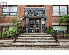 The front of a building with a sign that says "Mell Court".
