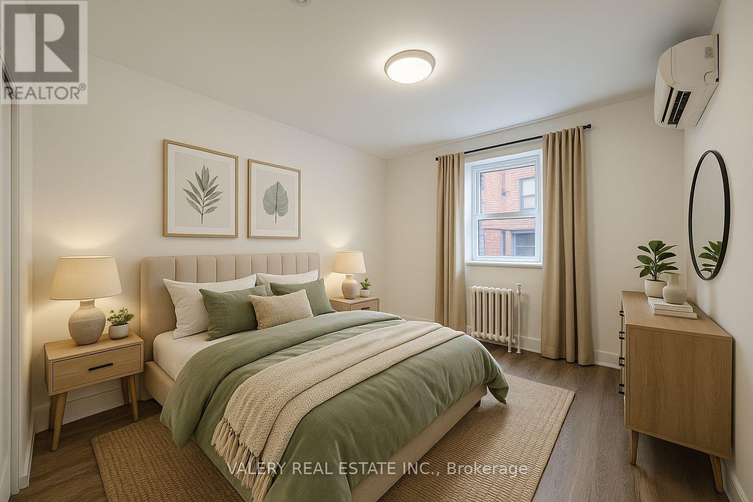 A bedroom with a bed, nightstands, and a window.
