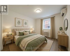 A bedroom with a bed, nightstands, and a window.