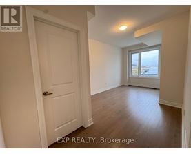 A room with a door and a window overlooking a parking lot.