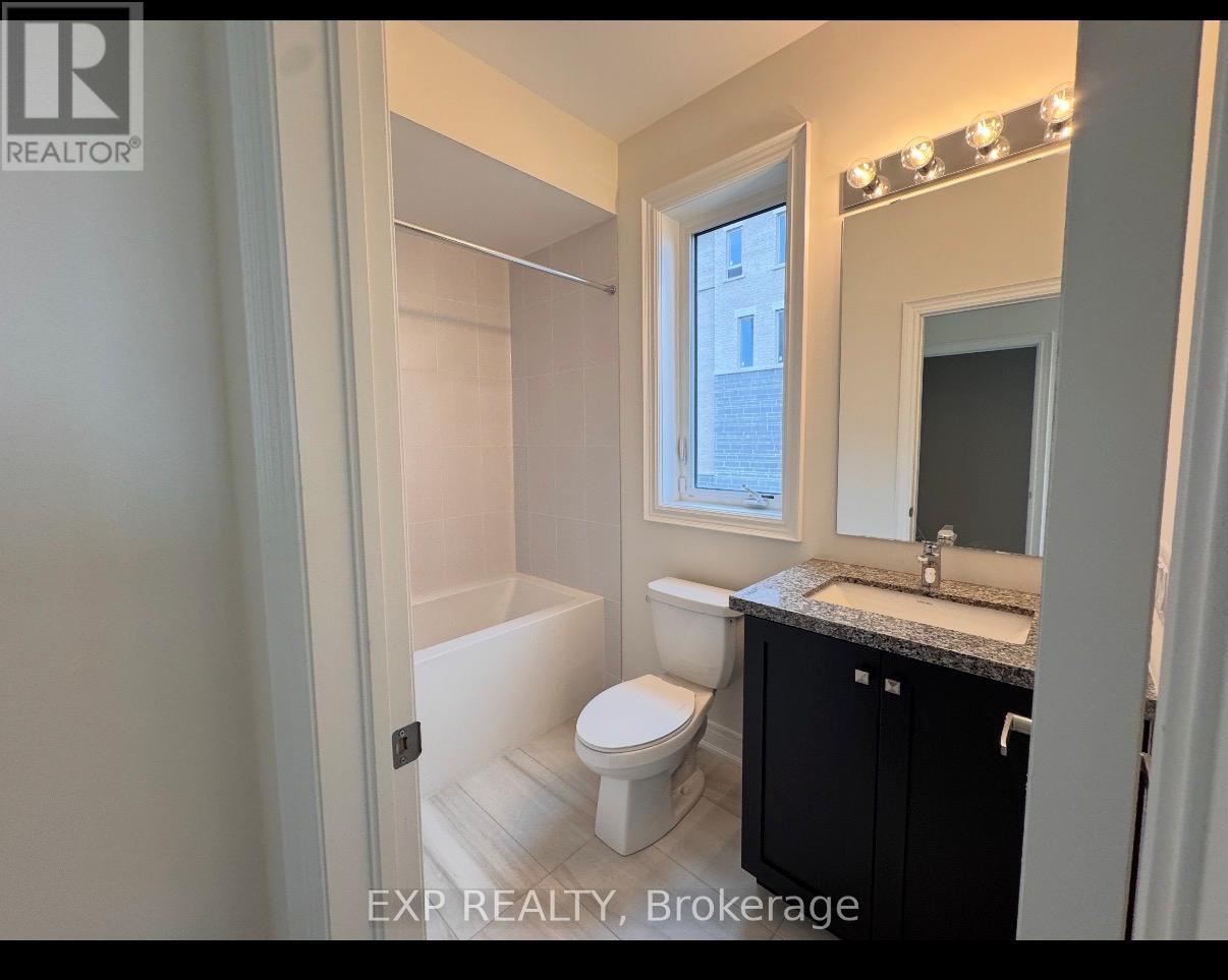 A bathroom with a toilet, sink, and mirror.