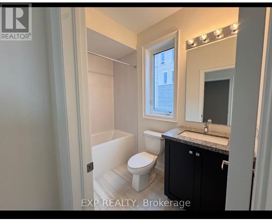 A bathroom with a toilet, sink, and mirror.