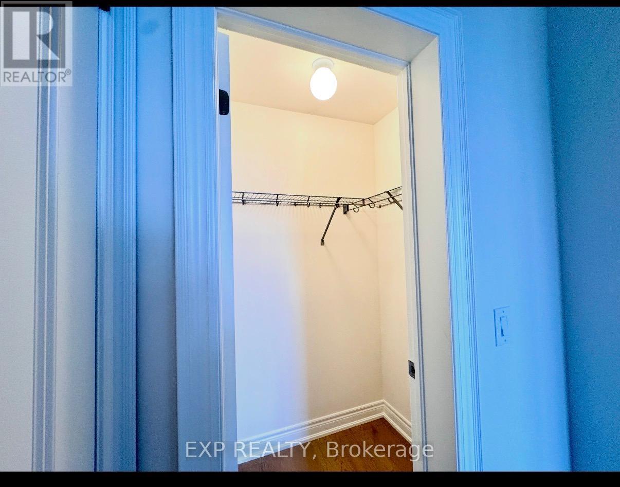 A small, empty room with a closet and a light on.