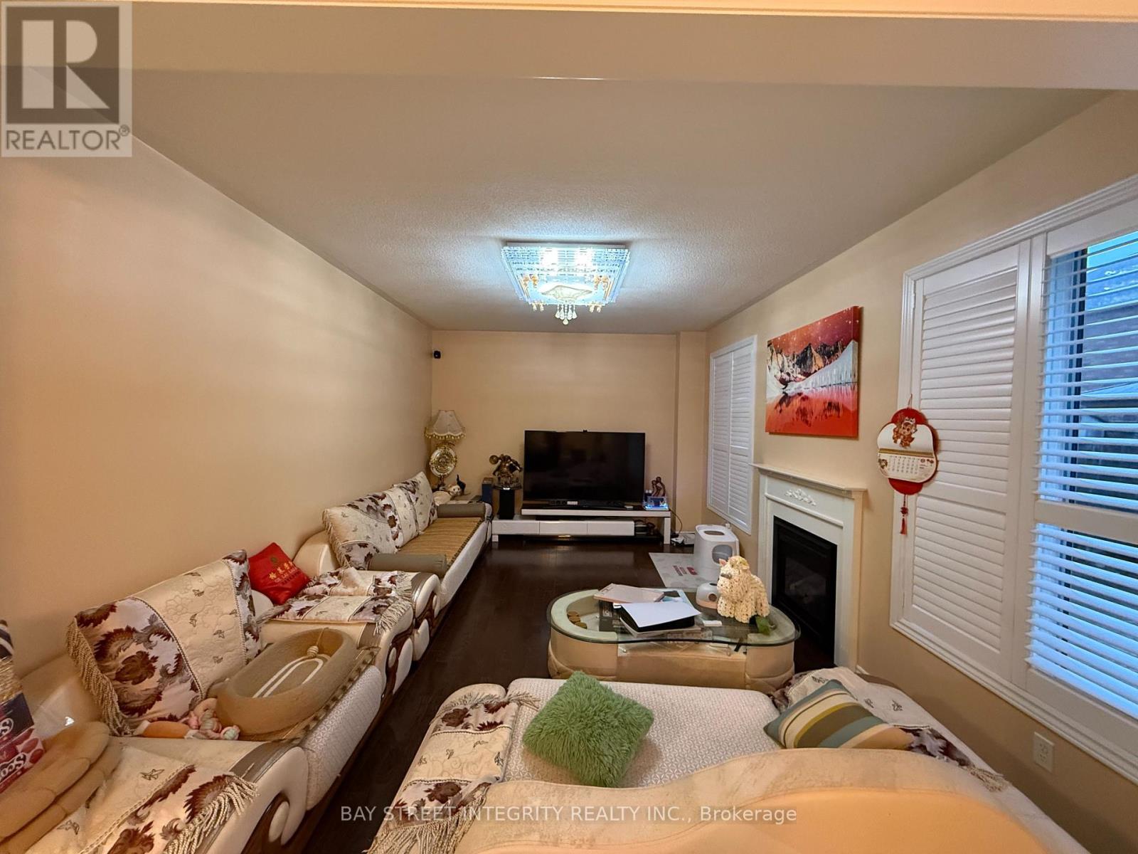 A living room with a couch, coffee table, and television.