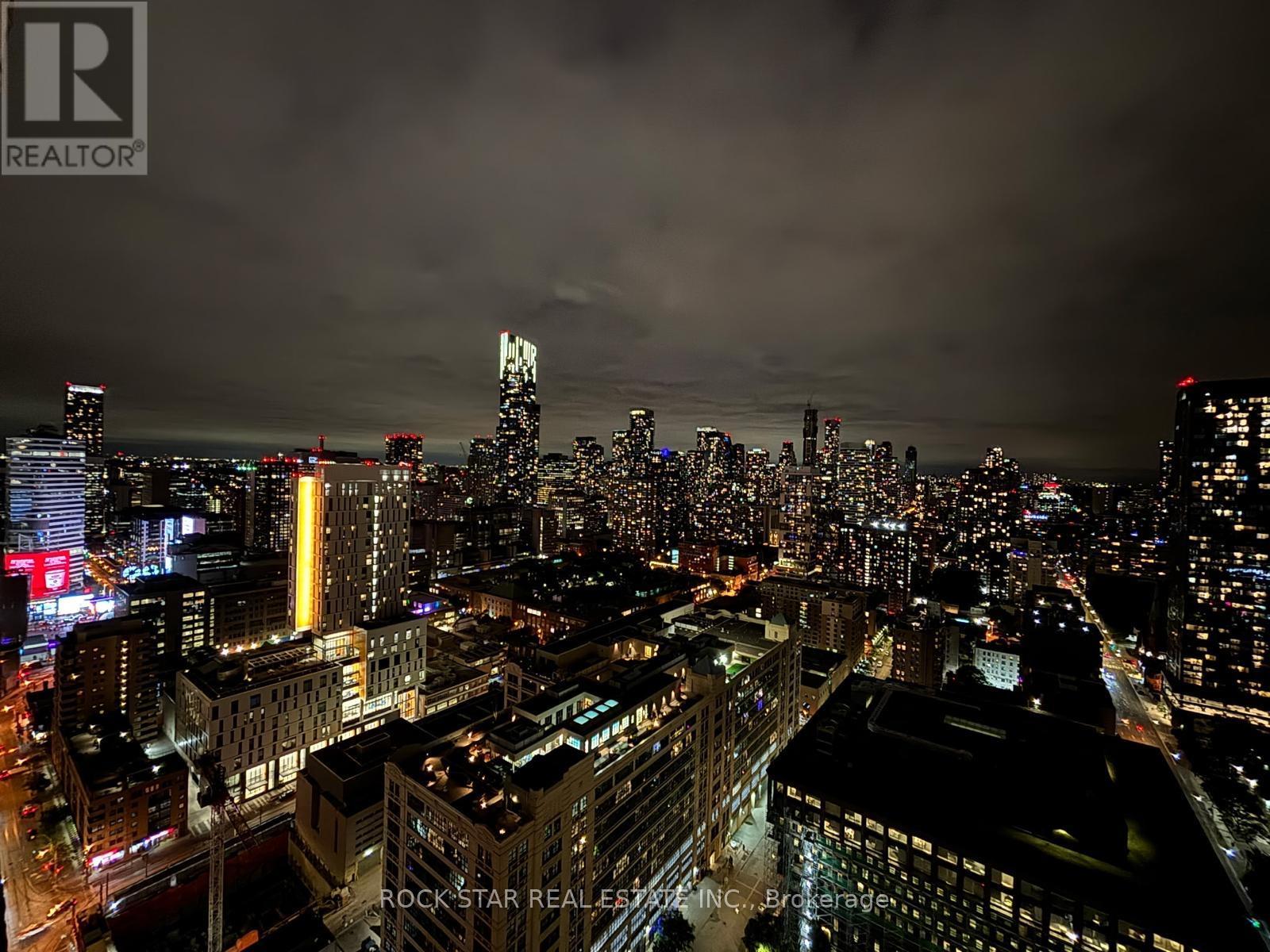 A cityscape at night with a dark sky.