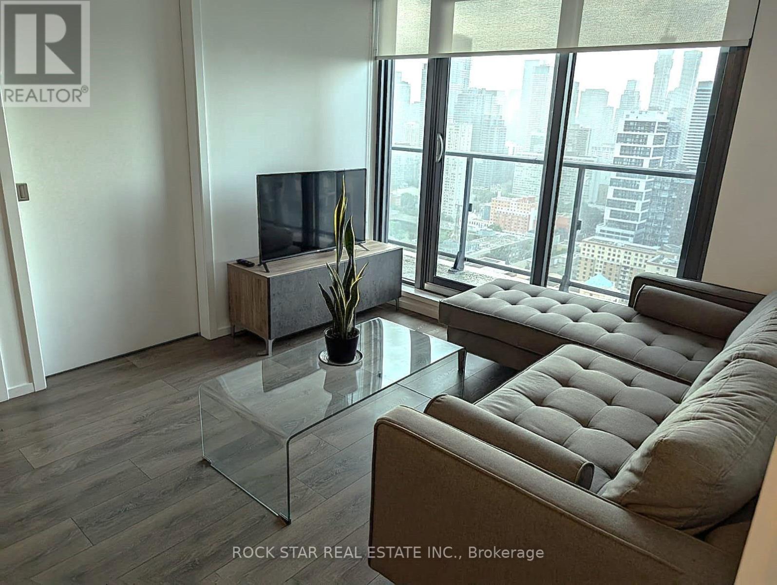 A living room with a flat screen TV and a couch.