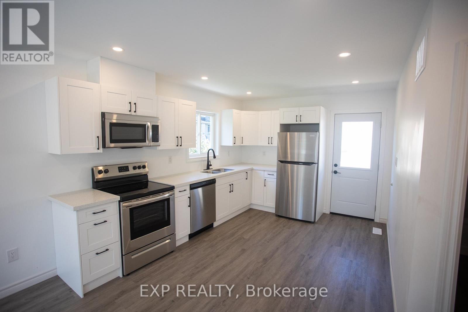 A kitchen with white cabinets and stainless steel appliances.