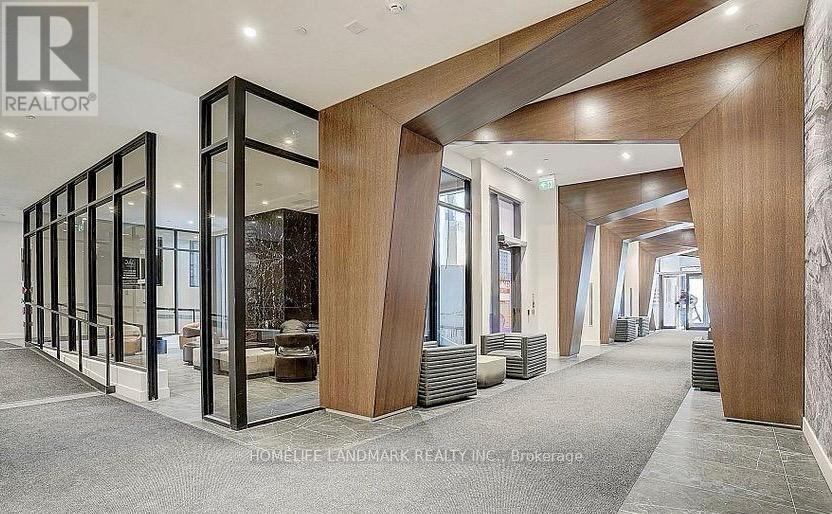 A spacious hallway with wooden columns and glass doors.