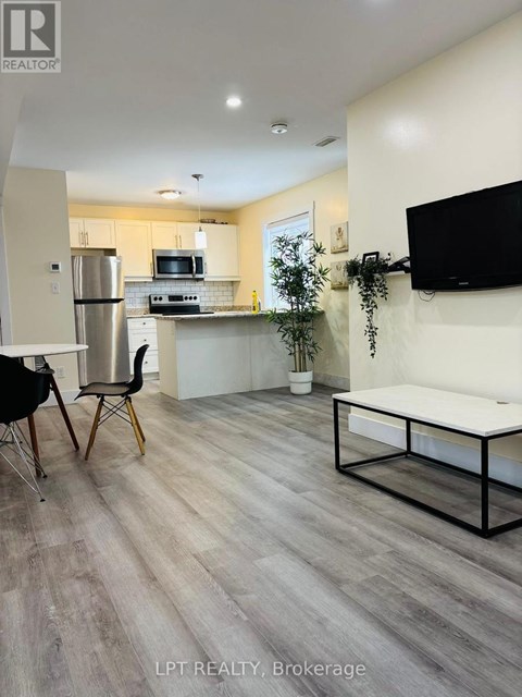 A modern kitchen with a dining table and chairs.