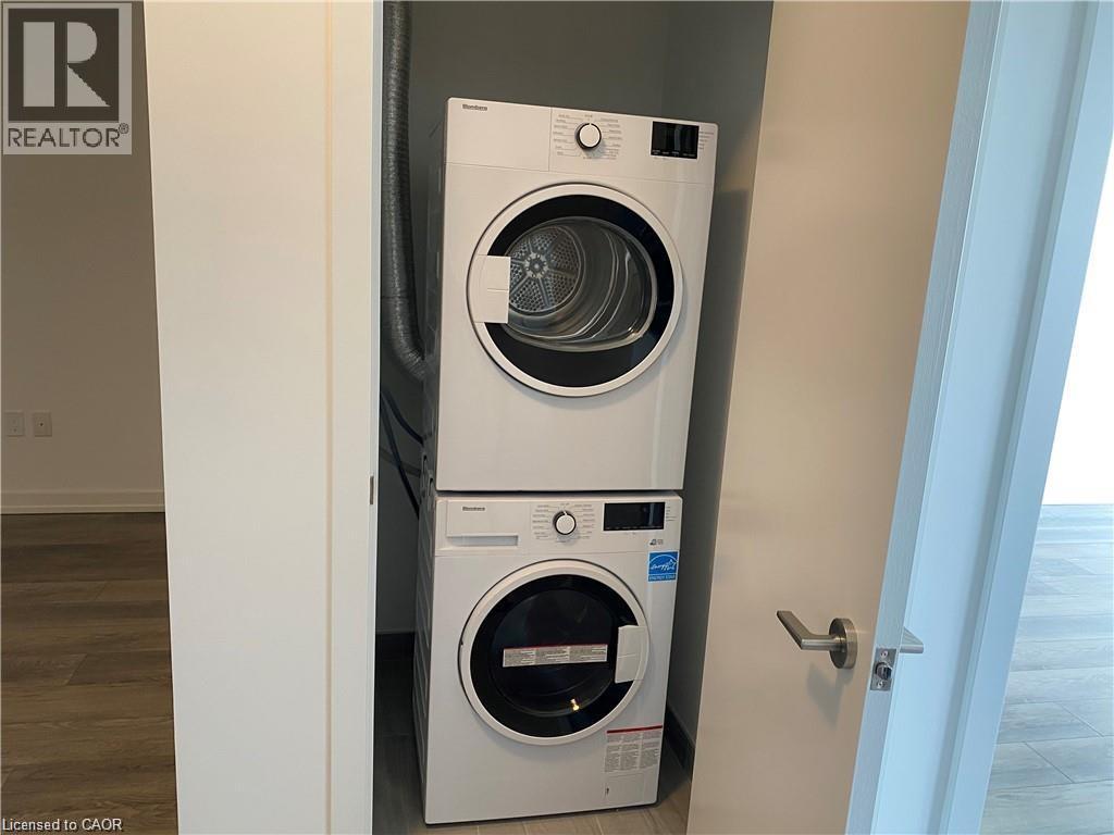 A white front loading washing machine in a laundry room.