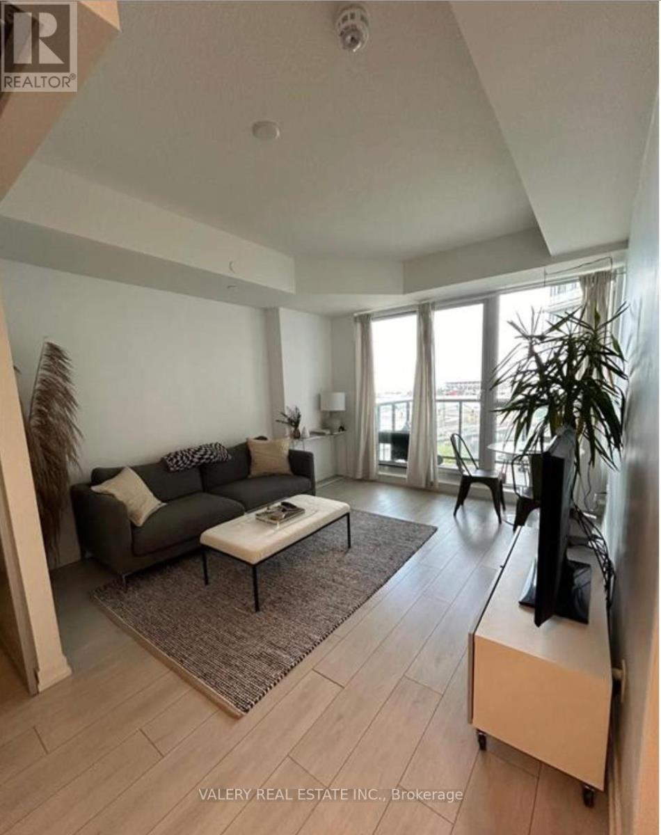 A living room with a couch, coffee table, and television.