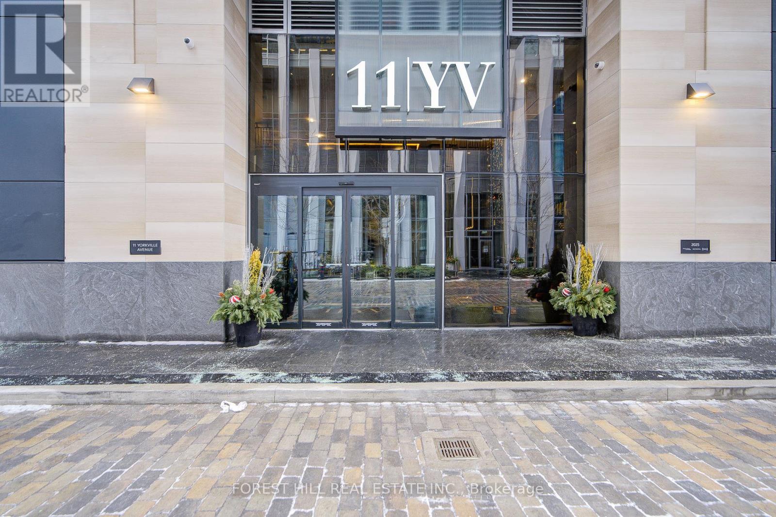 The front of a building with the sign 11YV and a Realty logo.