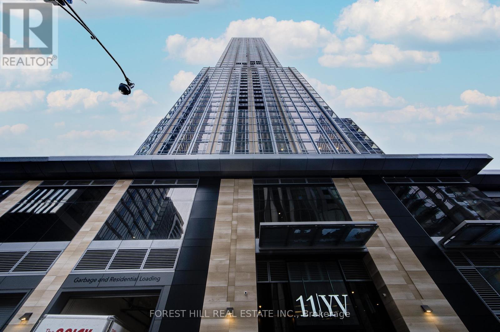 A tall building with the words "Forest Hill Real Estate Inc." on the front.
