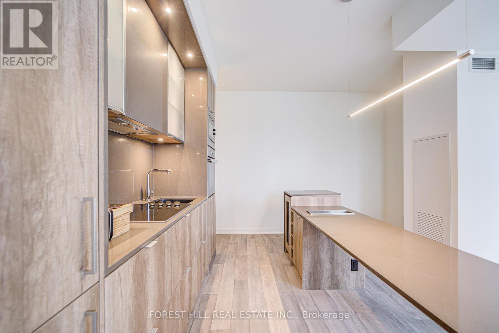 A modern kitchen with wooden cabinets and a countertop.