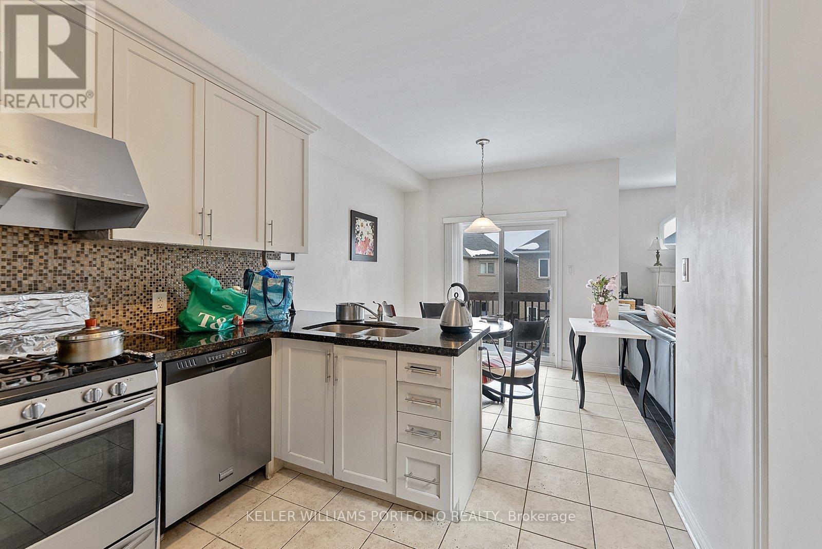 A kitchen with a stove top oven and a range hood.