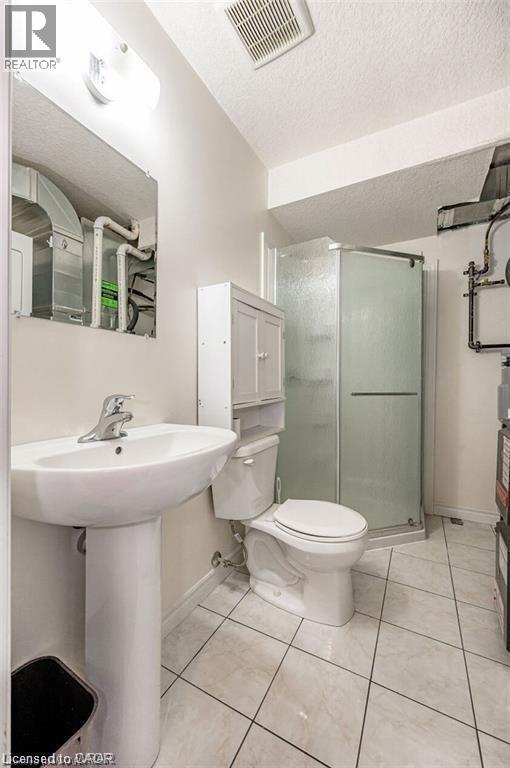 A white sink and toilet in a small bathroom.