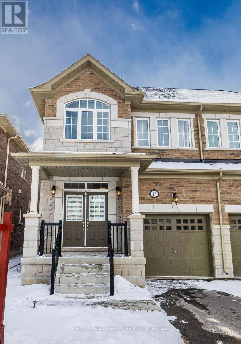 A house with a brown garage door and a red fence in front.