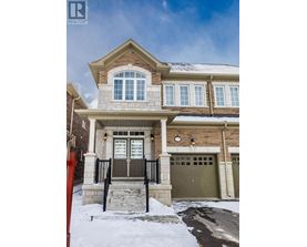 A house with a brown garage door and a red fence in front.