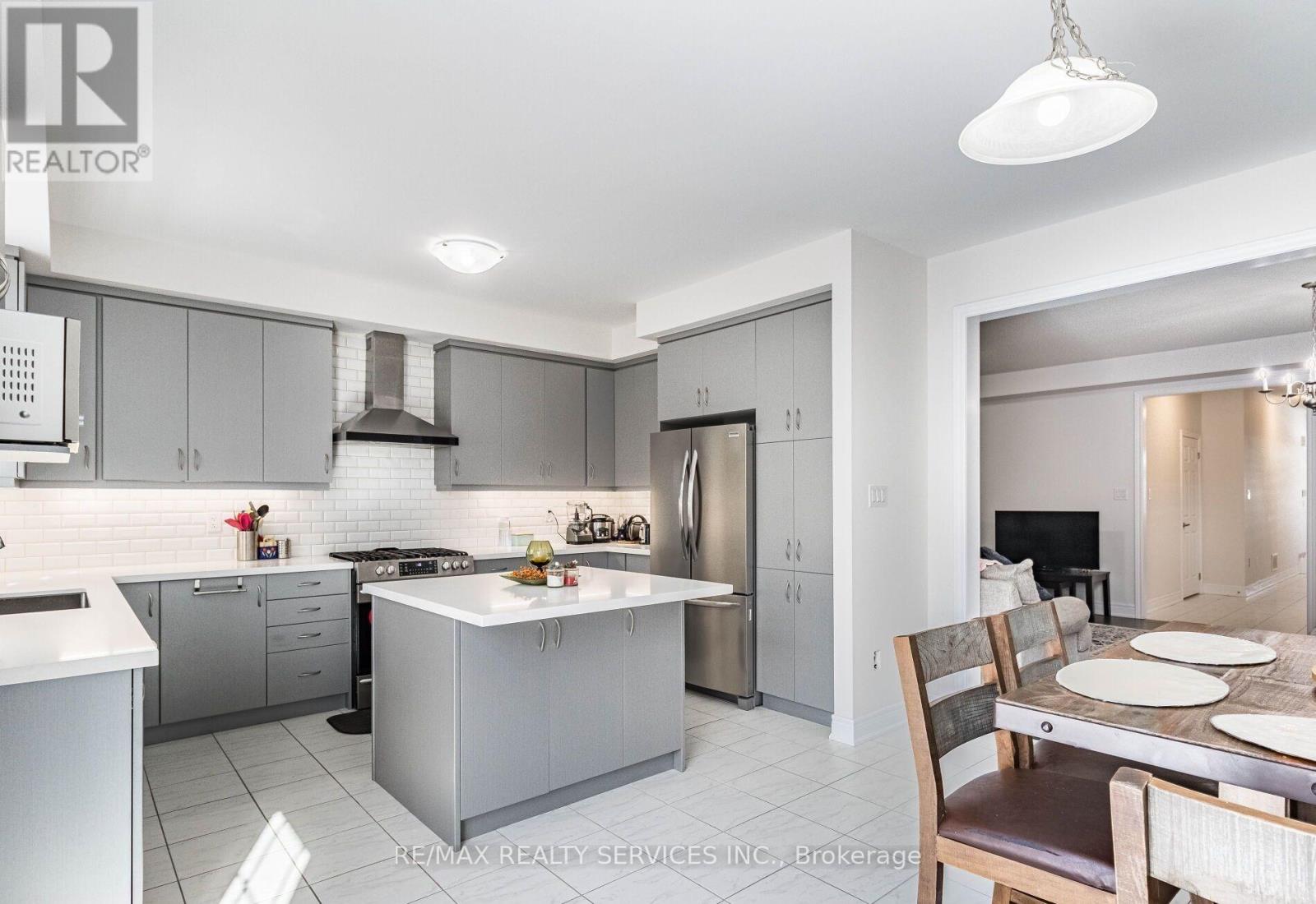 A modern kitchen with a dining table set for two.