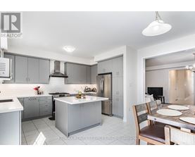 A modern kitchen with a dining table set for two.