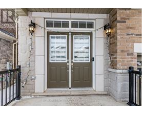 A house entrance with a green door and a sign that says RE/MAX Realty Services INC Brokerage.