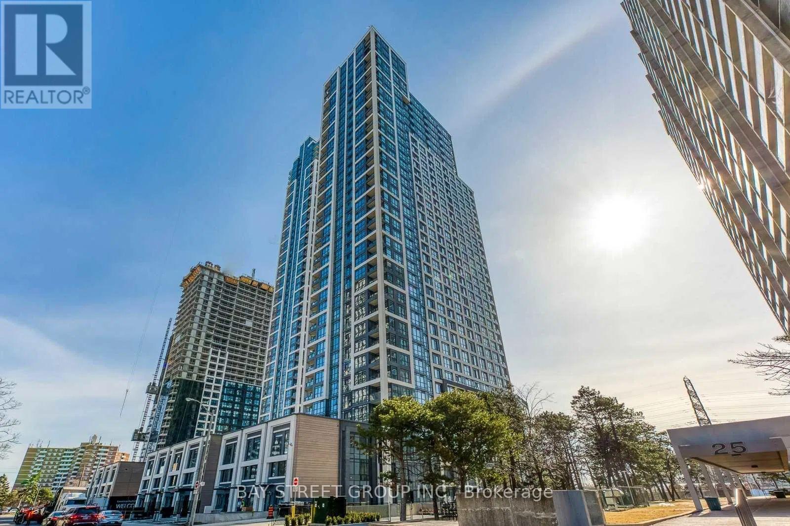 A tall building with many windows is the main focus of the image.