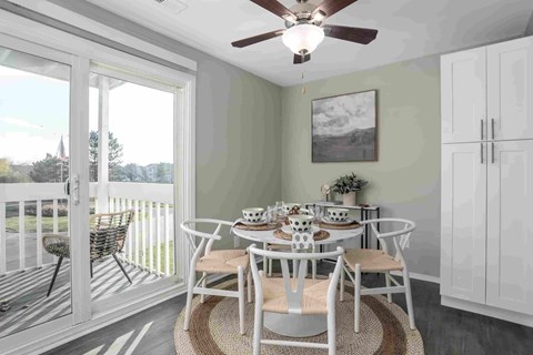 A dining room with a table set for a meal.