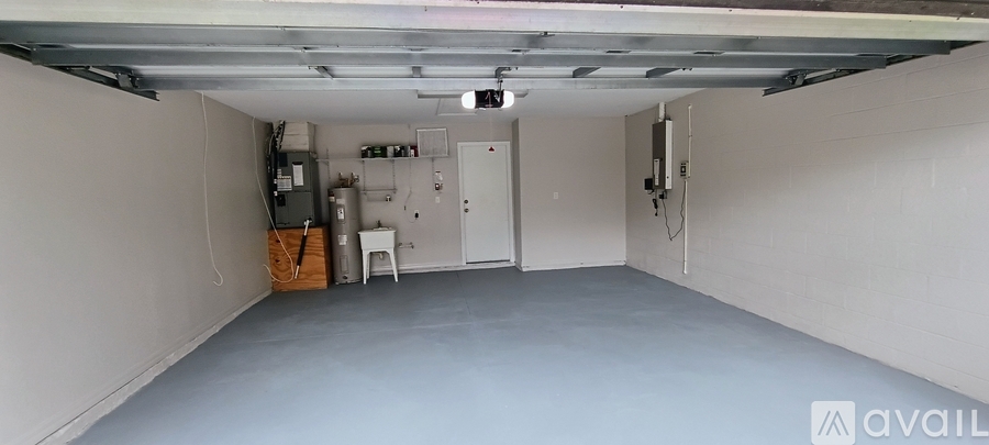 A spacious garage with a white cabinet and a white chair.