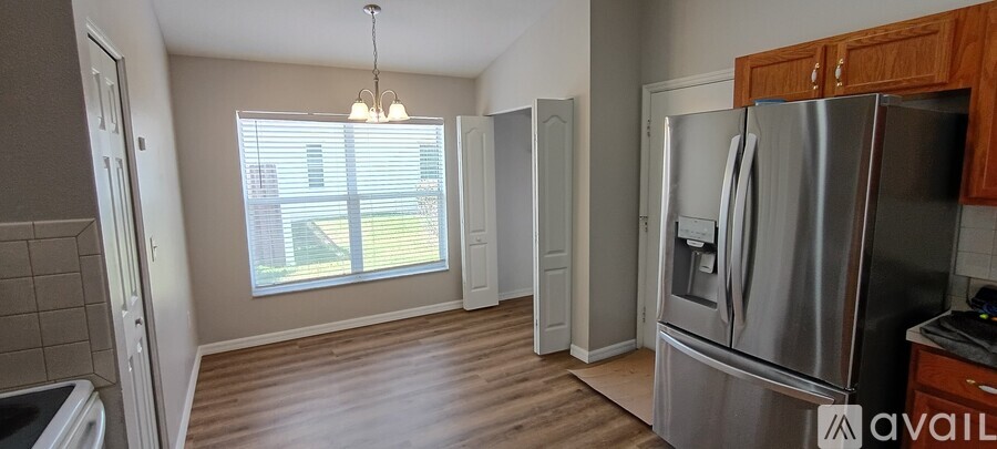 A kitchen with a refrigerator, stove, and oven.