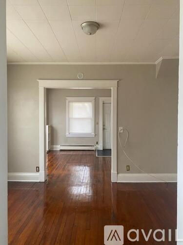 A room with wooden floors and white walls.