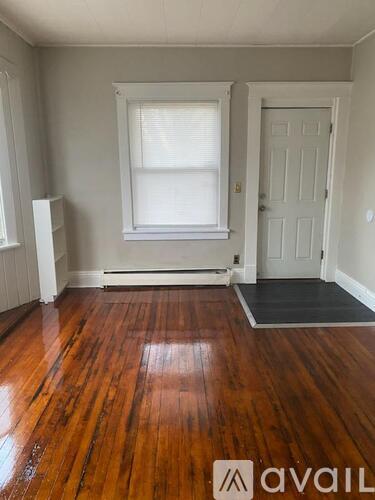 A room with wooden floors and a white door.