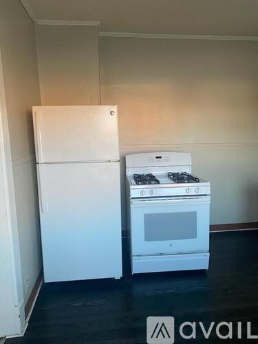 A white fridge and stove in a room.