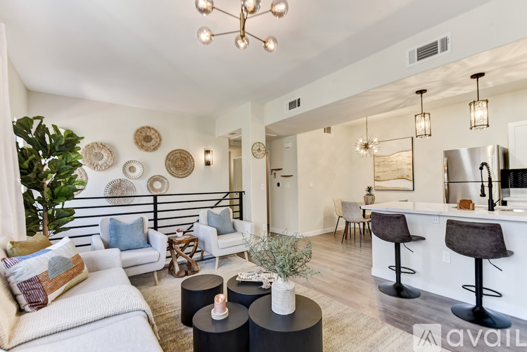 A living room with a white couch and a bar area.