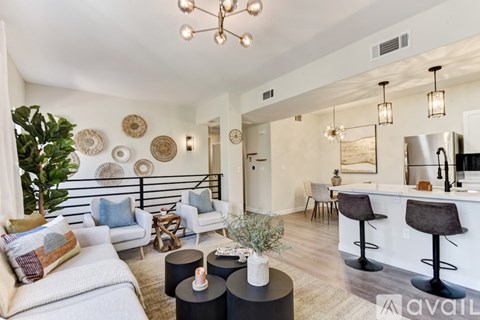 A living room with a white couch and a bar area.