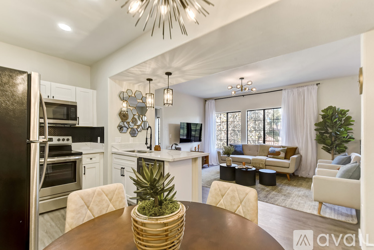 A modern kitchen with a dining table and chairs.