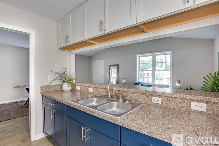 A kitchen with a sink and a window.