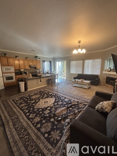 A living room with a rug on the floor and a couch.