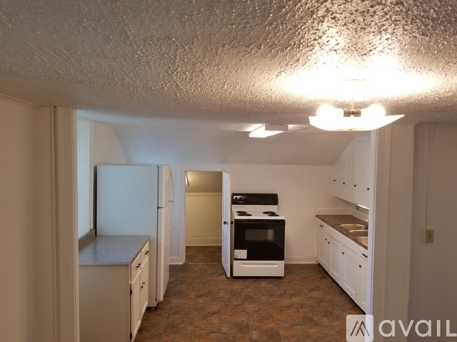 A kitchen with white cabinets and a black stove top oven.