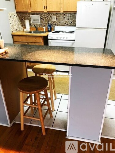 A kitchen with a white refrigerator and a counter top.