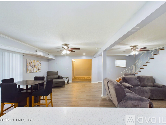 A living room with a dining table and chairs.