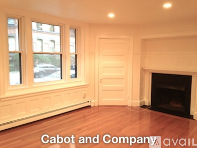 A room with a fireplace and a window.