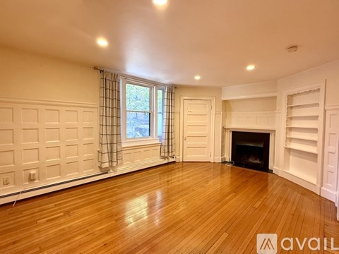 A room with a fireplace and a window.