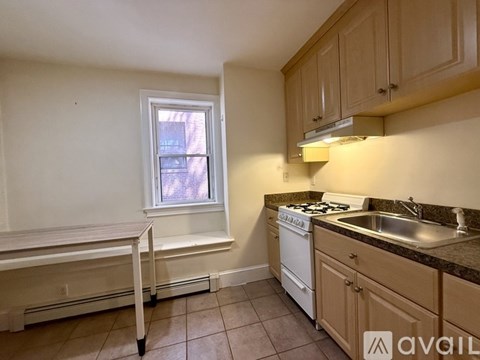 A white wall with a heater under it.